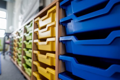 Rows of yellow and blue classroom trays