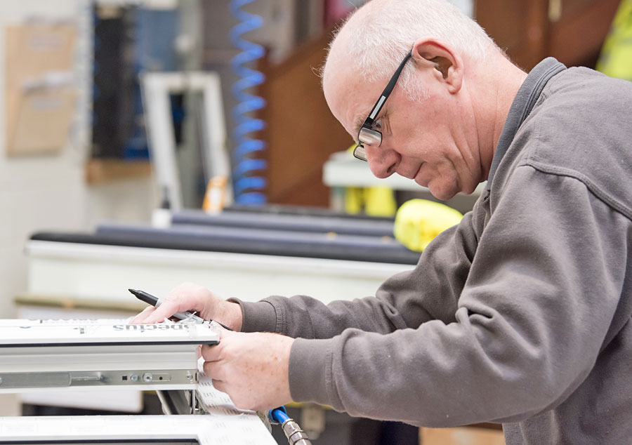 Factory-Shot-Worker-Marking-up-a-Window